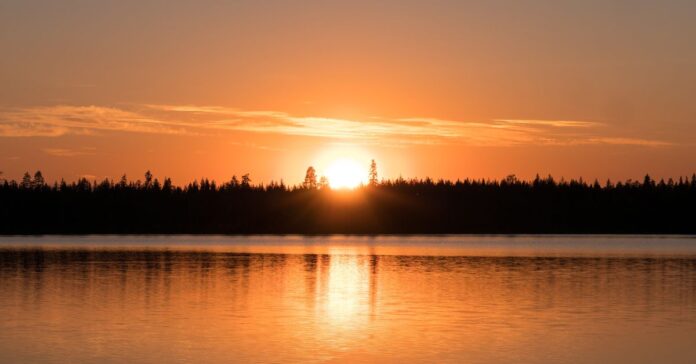 Midnight sun visible over an Arctic landscape